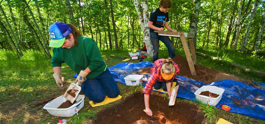 Students dig and screen for artifacts as part of a Field Research in Archaeology class taught on campus and at a site along Skyline Parkway in Duluth.