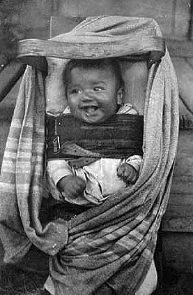 Ojibway baby in cradle board, Mille Lacs Indian Reservation, ca. 1909.