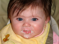 Claire Kathleen Roufs eating first food at 5 months.