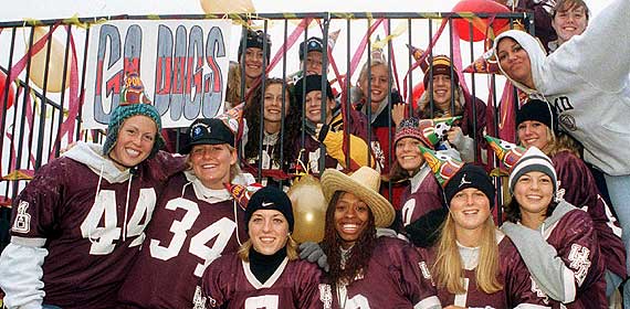 The women's basketball team celebrates on a homecoming float.