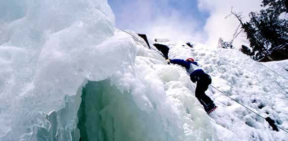 Students ice climbing on a local icefall.