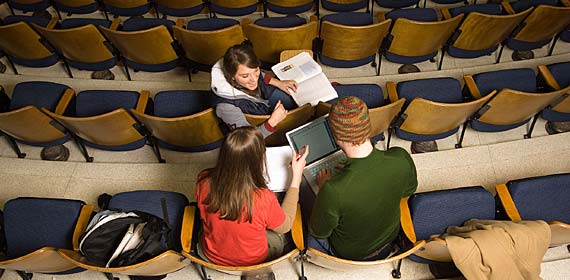 Students compare notes after a class in a Life Science lecture hall.
