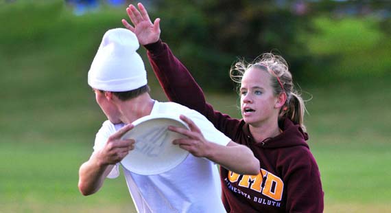 UMD students play ultimate frisbee on campus.
