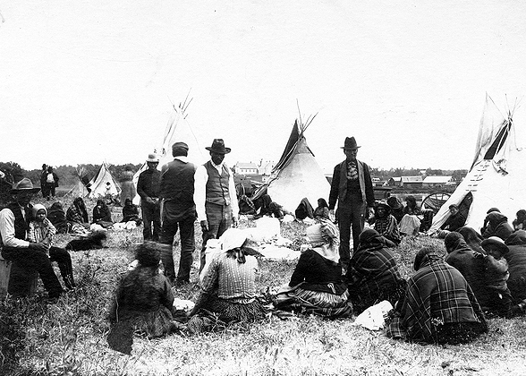 Issuing flour to Ojibway women at June festival, White Earth Reservation, 1896.