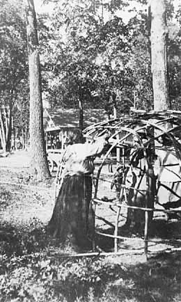 Ojibwe Indians building wigwam at Mille Lacs Trading Post.
