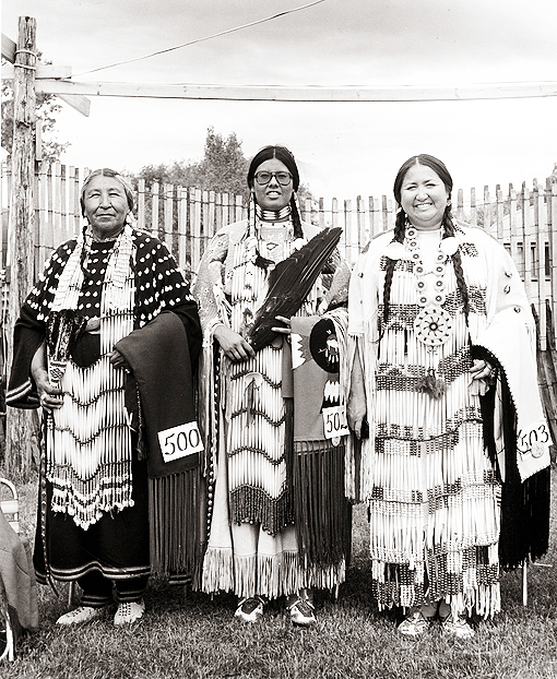 Alice Red Elk and two other Dakota women from South Dakota in traditional dancing attire, Pipestone powwow, 1978.