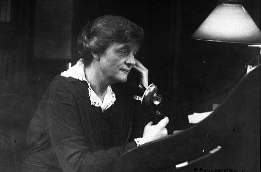 Elizabeth Wallace talking on the telephone, 1910.