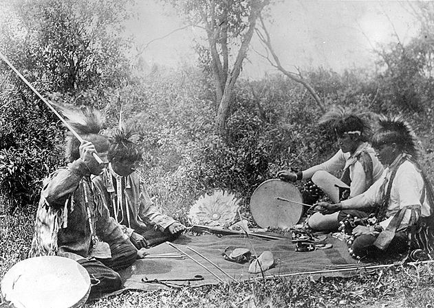 Group of Native American men playing moccasin games, 1926 - 1959.