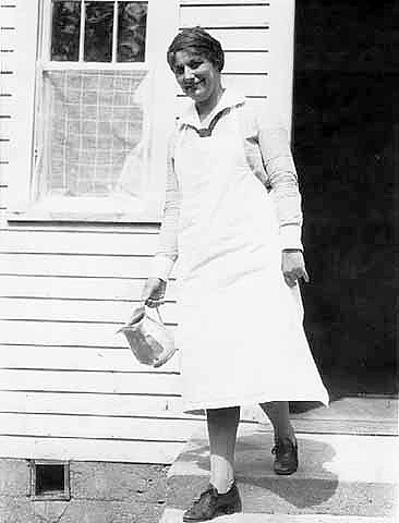 Woman carrying a pitcher, possibly nurse working for Minnesota Health Departments Indian health service, ca. 1930.