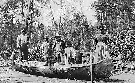Ojibwe family by their canoe, ca. 1900.