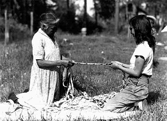 Women braiding rug, Bena, 1948