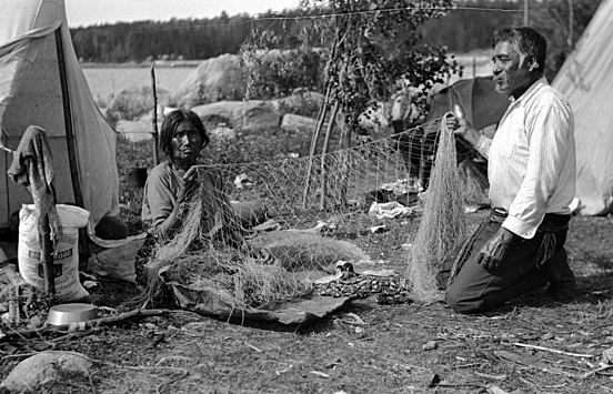 Indian man and woman mending net, Lake of the Woods, ca. 1922.