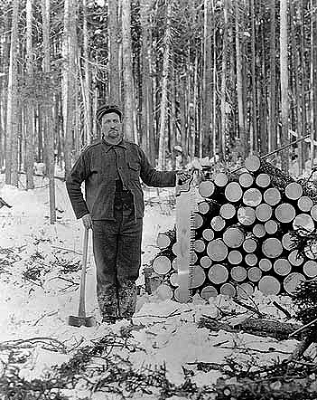 A typical lumberjack and his pile of wood, ca. 1910.