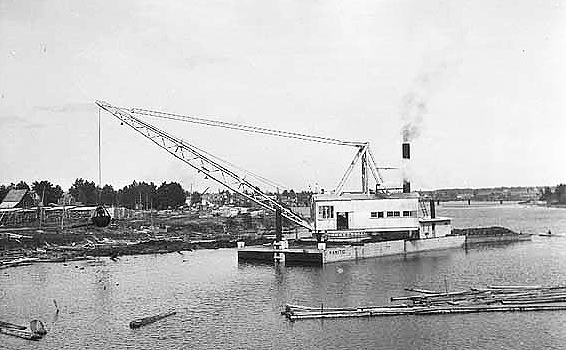 United States Dredge "Manito" and fleet, including quarterboats, at Cohasset, 14 May 1915.
