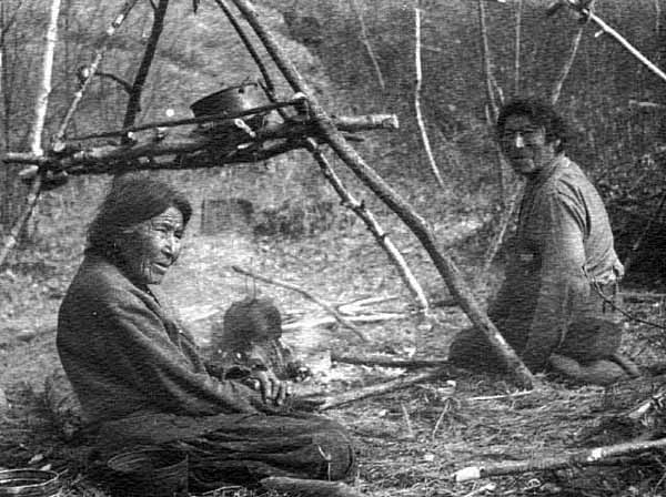 Chippewa women cooking over open fire, 1910