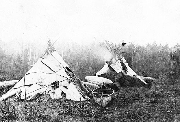Ojibway Indian camp with birch bark canoe, ca. 1870.
