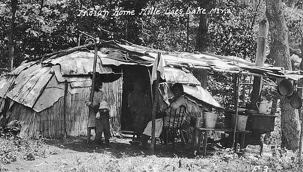 An Ojibway family at home, Mille Lacs Reservation. Note the cook stove on the right, ca. 1920.