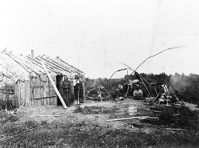 Indians in front of home, Leech Lake, 1900