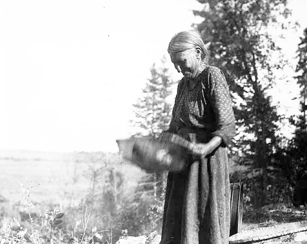 Woman fanning wild rice, ca. 1925.