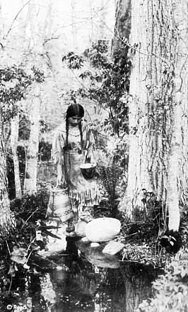 Ojibway woman carrying water, 1920