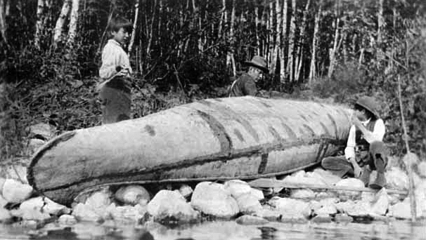 Indians repairing canoe, 1918