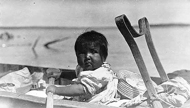 Indian baby in canoe at Rainy Lake.