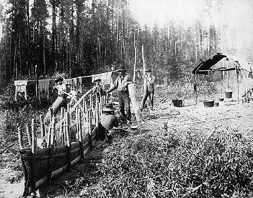 Building birch bark canoe at a Chippewa camp, ca. 1895.