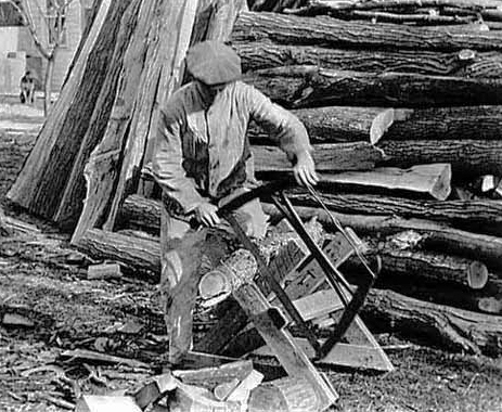 Sawing wood for household use on the farm, ca. 1920.