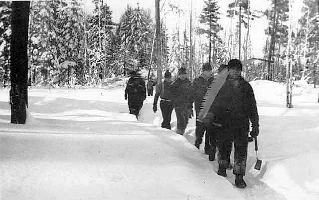 Lumberjacks returning from a day's work, ca. 1930.