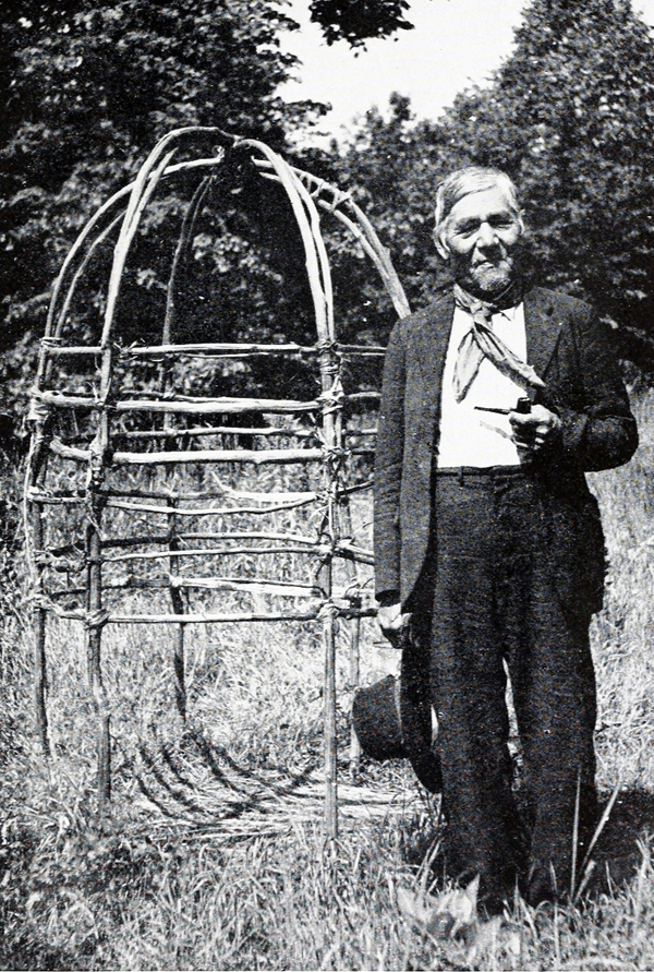 John King, beside his Shaking Tent, Sand Lake Chippewa, St. Croix Settlements, WI, 1942.