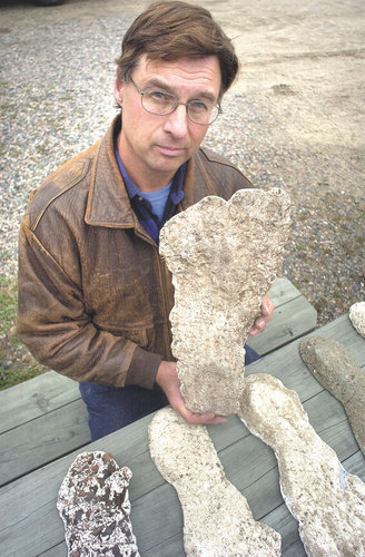 Robert Olson of Deer River holds a plaster casting that he made from what he says are footprints of Bigfoot beings in Northeastern Minnesota. (Lee Bloomquist / News Tribune)