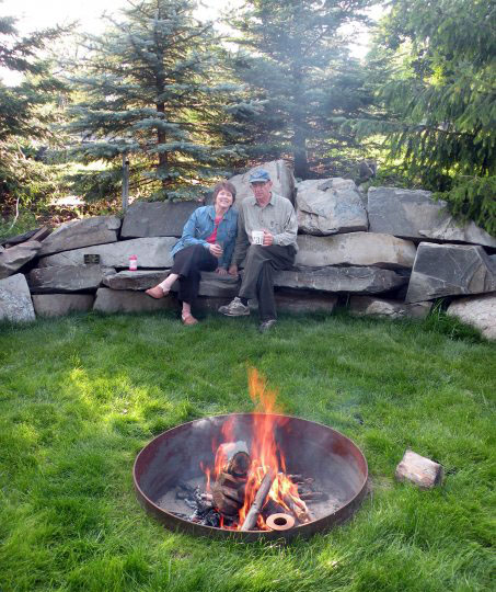 Kim and Tim Roufs by fire pit next to the Black Oven.