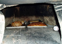 Meatloaf and bread in oven.