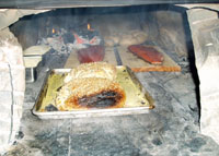 Salmon and bread in oven.