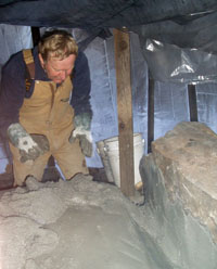 Pat applying second plaster coat.