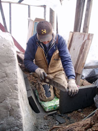 Pat cutting ridgid insulation for outside of oven.