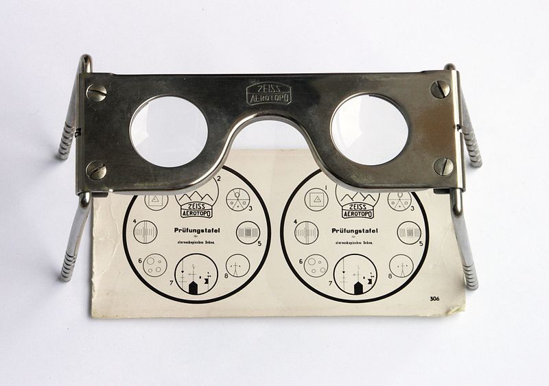 Pocket stereoscope with original test image. Used by military to examine stereoscopic pairs of aerial photographs.
