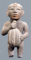 Aztec statuary of a male figure holding a cacao pod.