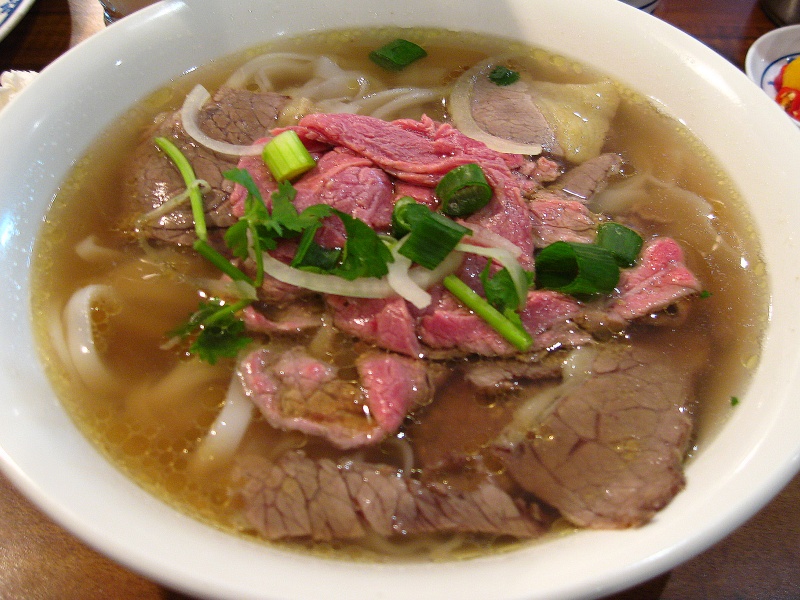 Vietnamese phở noodle soup with sliced rare beef and well done beef brisket. 