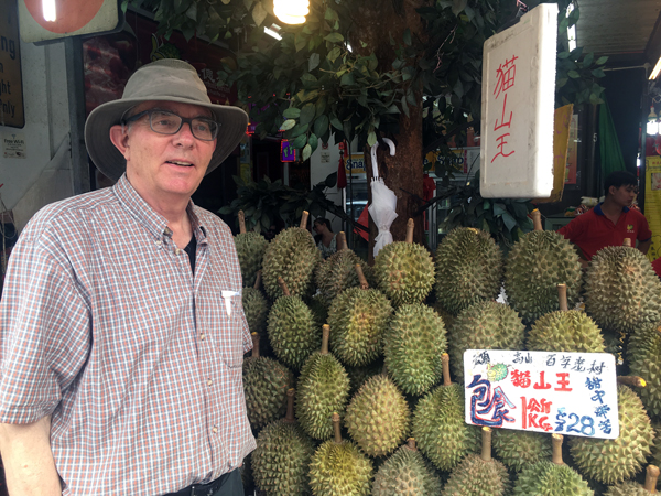 Tim Roufs checking durians at Singapore market, 2017.