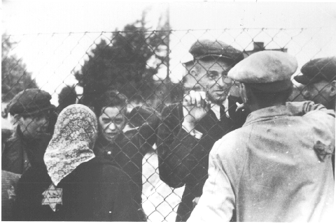 People on opposing sides of a fence