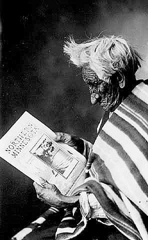 John Smith with book on northern Minnesota, ca. 1910.