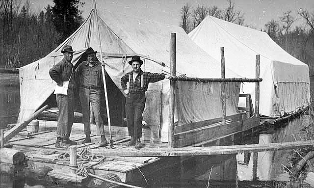 Two "sleeping" wanigans temporarily pulled up to the bank, ca. 1922.