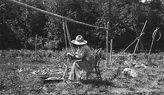 Mrs. Rozer drying fish nets, 1910