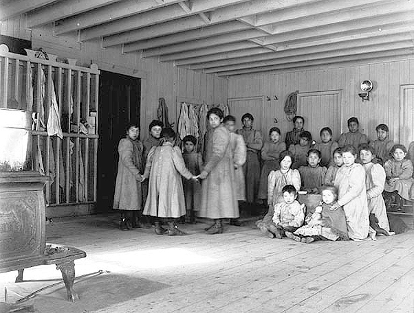 Young girls playing at an Indian boarding school, location unknown, ca. 1900.