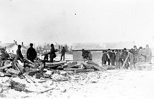 Splitting wood at an Indian boarding school, location unknown, ca. 1900.