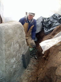 Pat applying ridgid insulation layer.