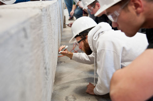 UMD students breaking test concrete beam