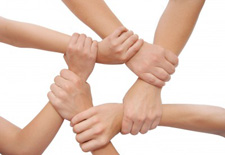 circle of interlocking hands on wrists